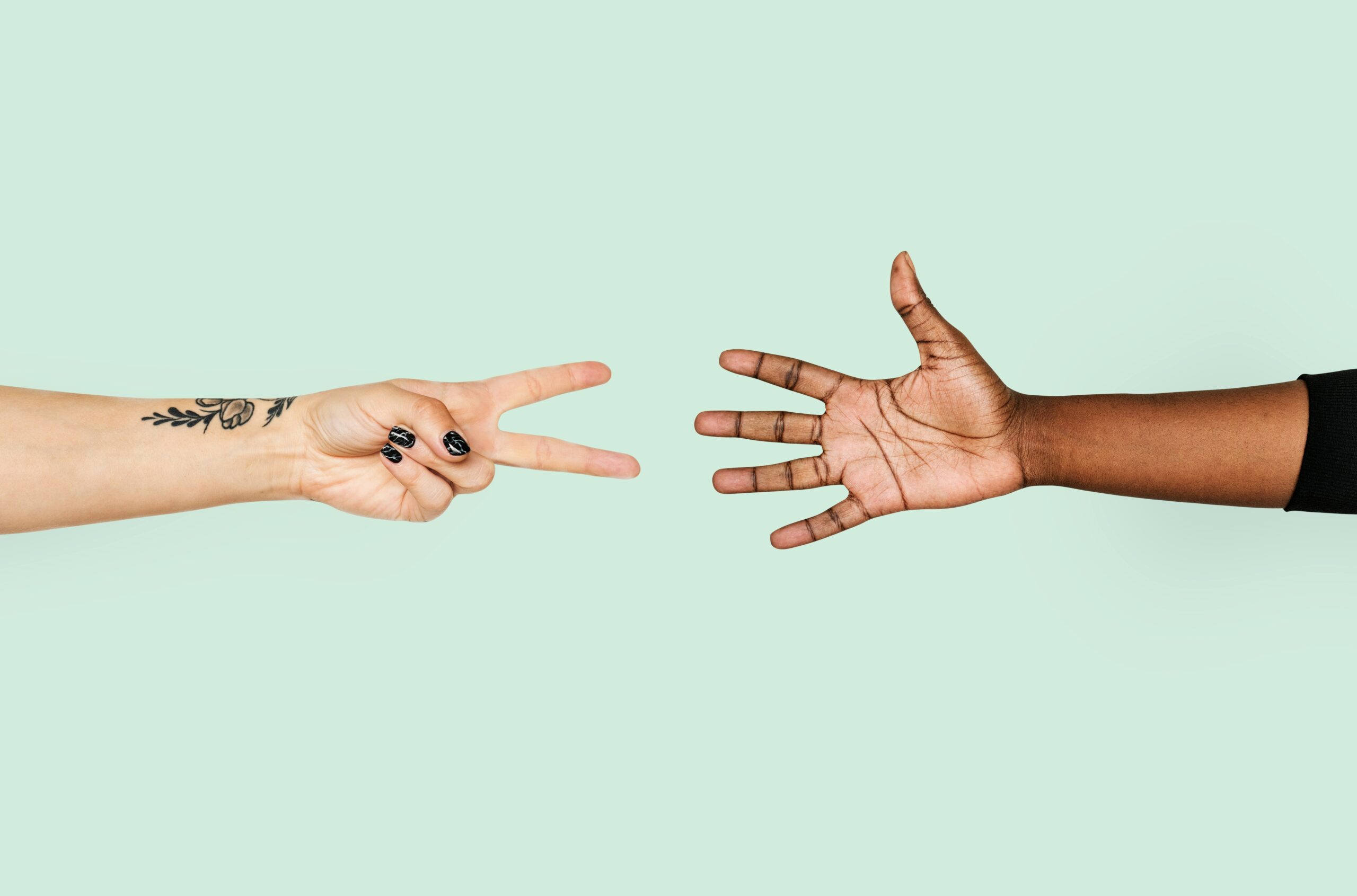two hands. one making a peace sign, one just holding the hand open